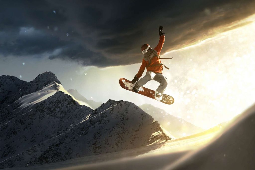 Snowboarder maakt een sprong bij zonsondergang