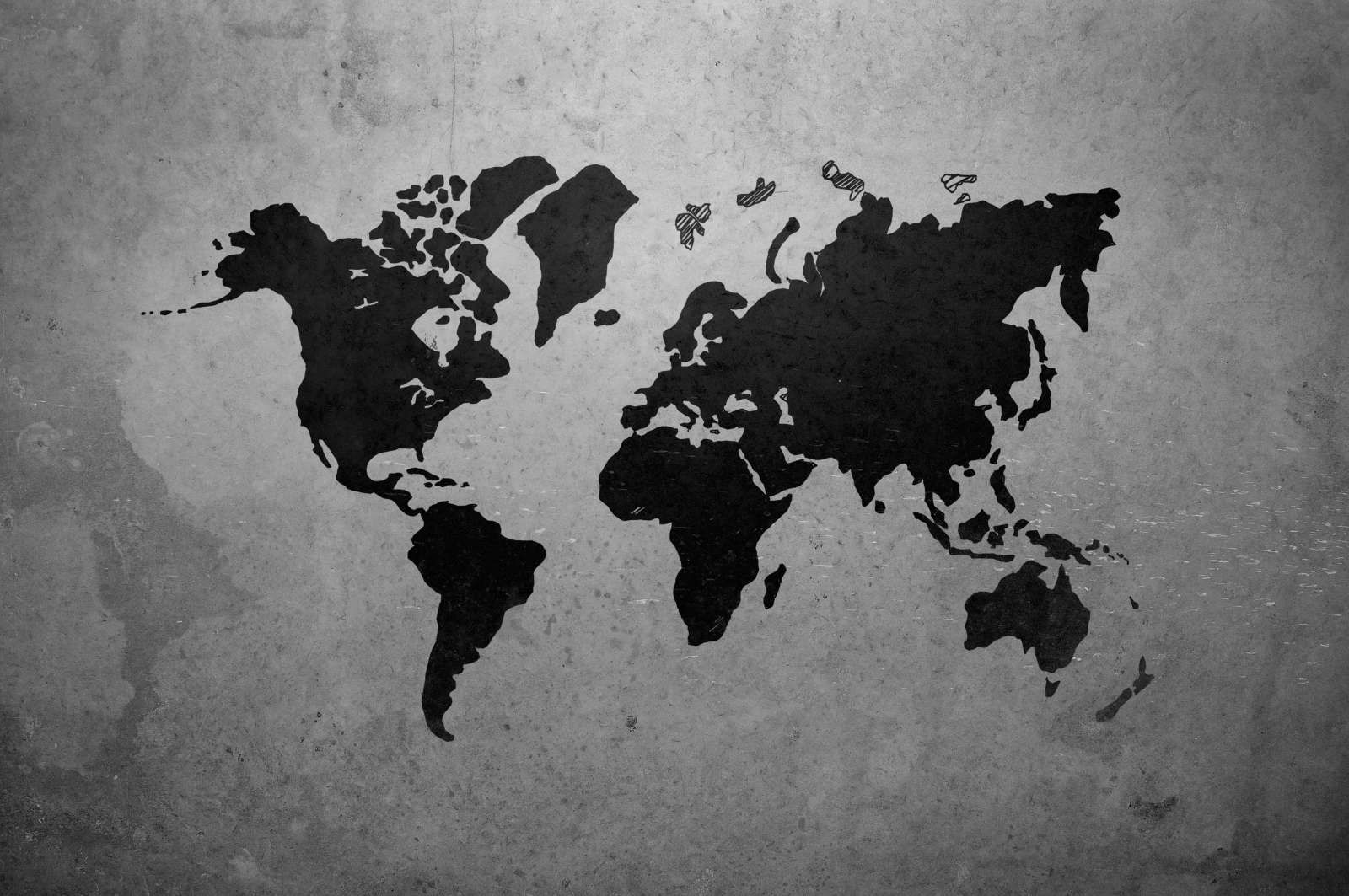Zwarte wereldkaart op een betonnen muur
